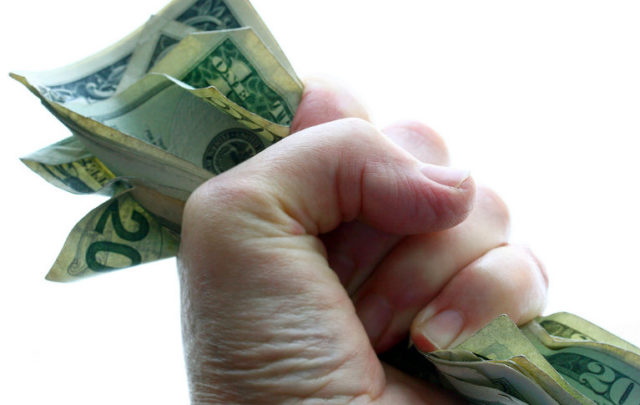 Money clutched in hand