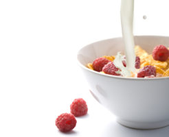Corn flakes and milk in bowl g