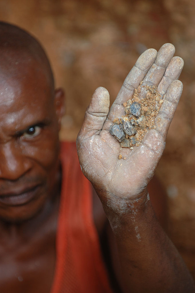 Wolframite and Casserite in the hands of a miner in the Democratic Republic of the Congo.