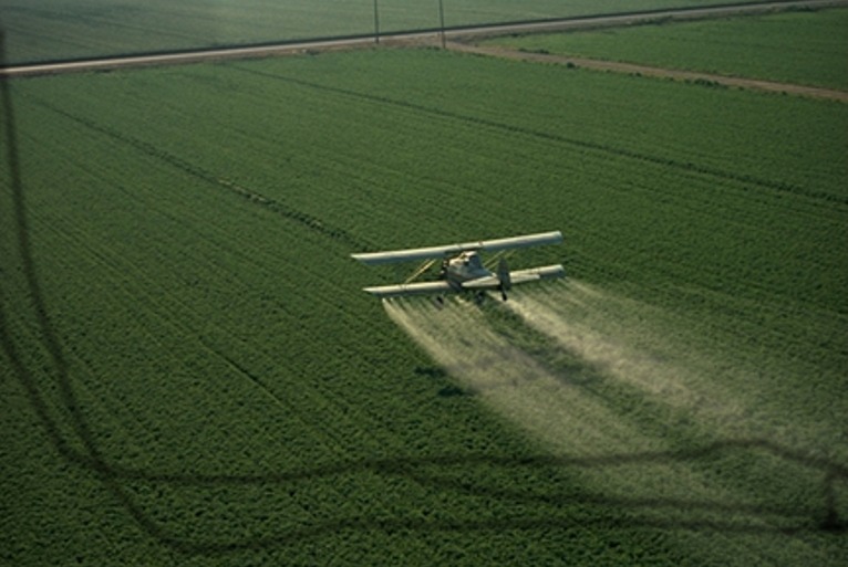 Cropduster spraying pesticides