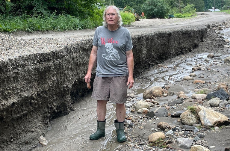 Erin's grandfather standing in a flooded ditch