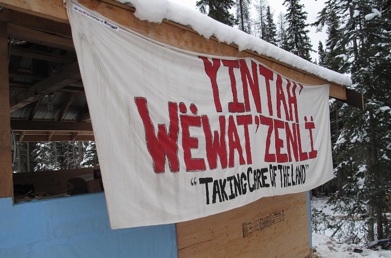 A banner at Unistʼotʼen camp in 2012